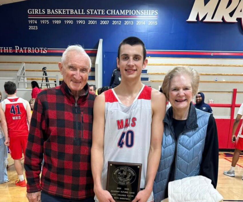 Samuel Prince, center, celebrates his MVP award with his grandparents, Jimmy and Phyllis Prince.